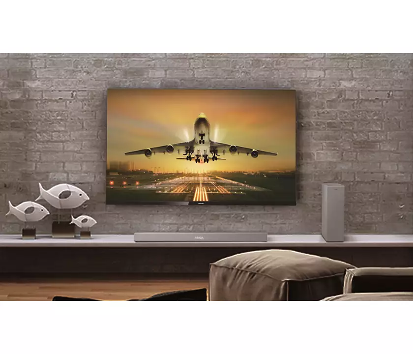 Barre de son et caisson basse Phillips TAB85051 sur un meuble TV